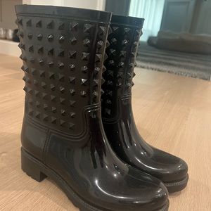 Black studded rain boots.